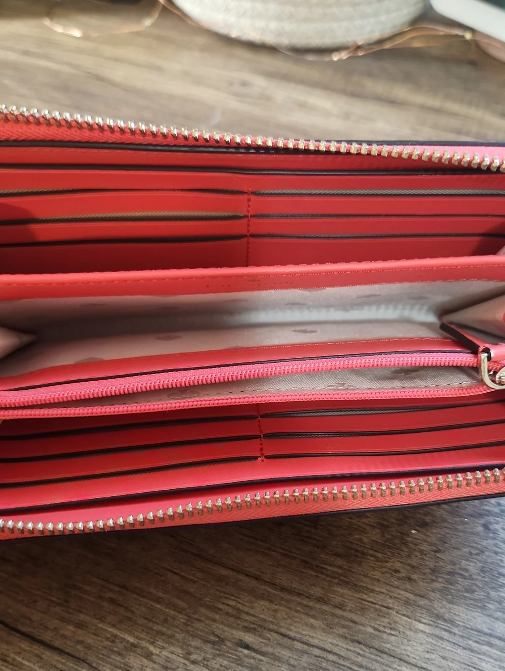 kate spade coral zip-around wallet with gold logo